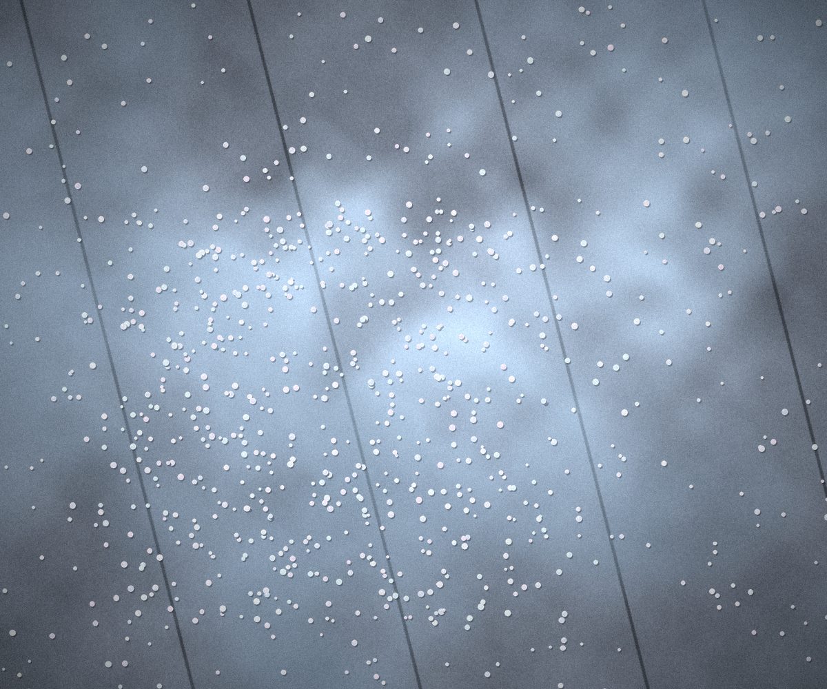 Ice melt pellets scattered across an icy concrete walkway